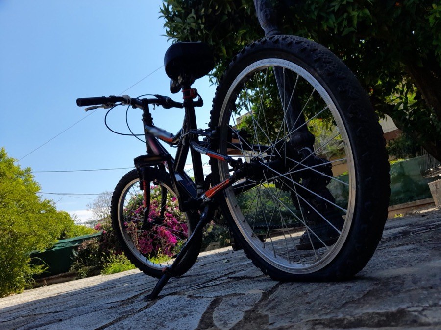 Low view of a bike with a completely flat rear tire