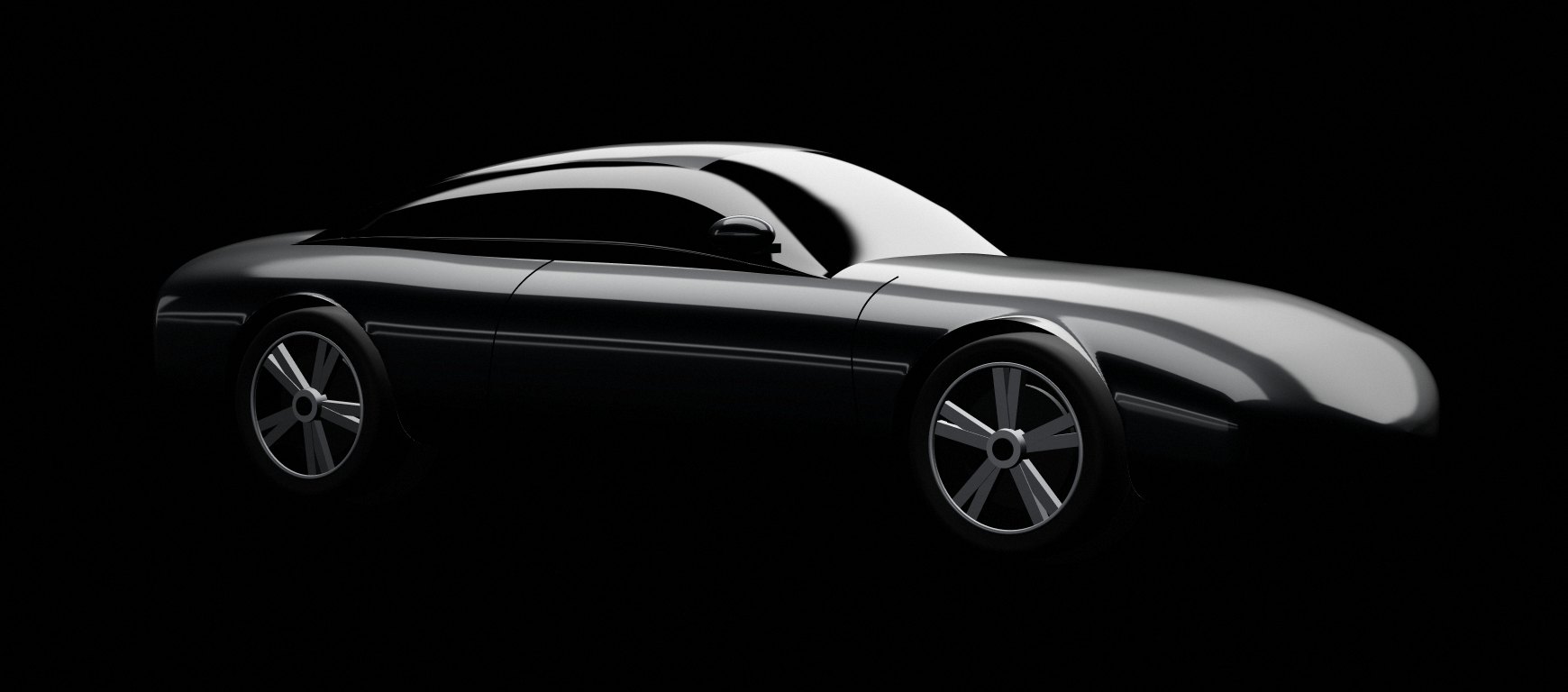 A dark grey coupe under studio lights