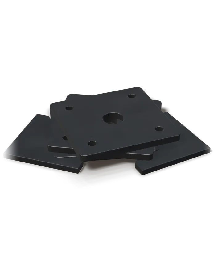 A stack of drilled steel base plates with two gussets.